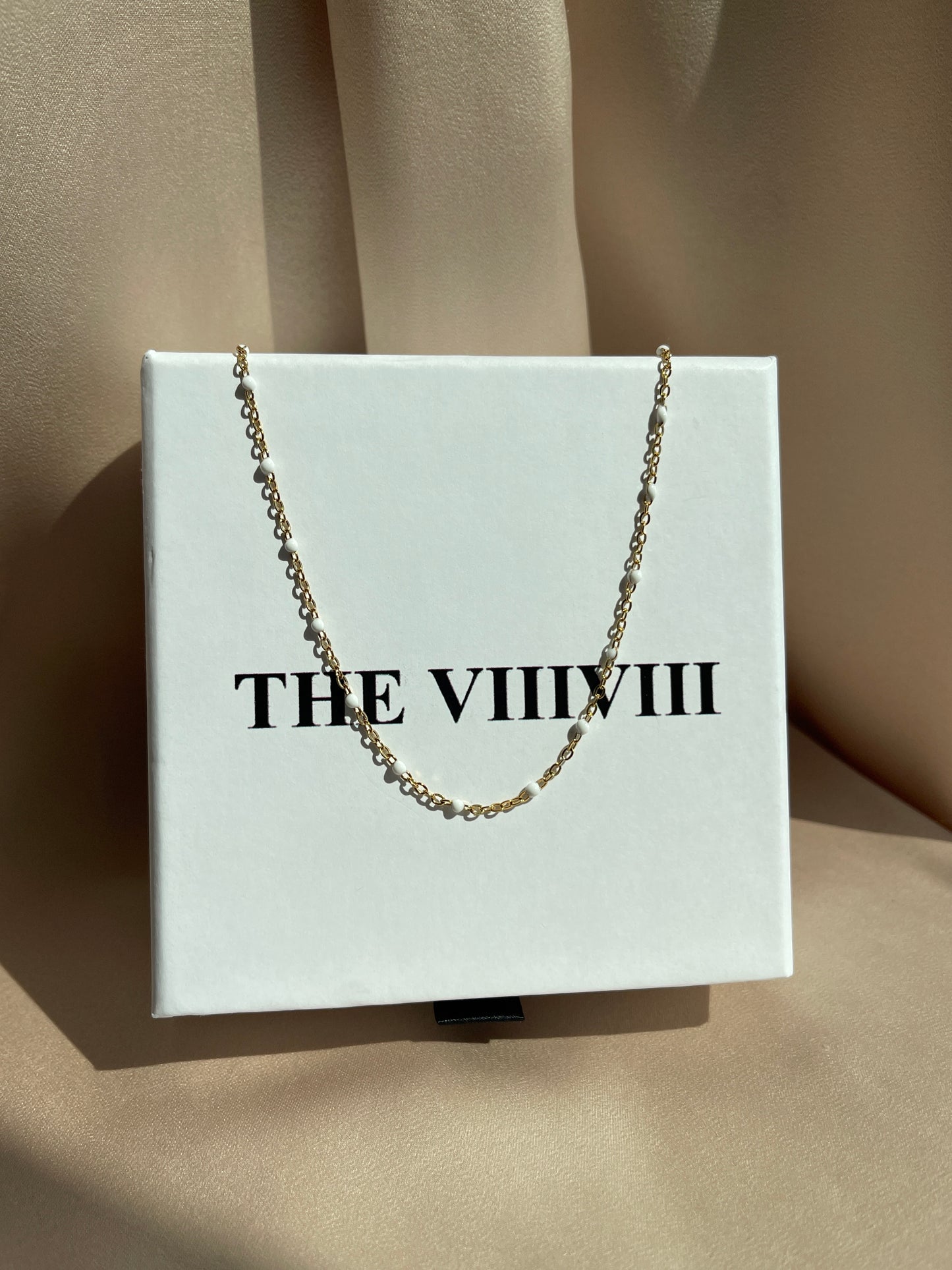 White enamel chain gold 
necklace