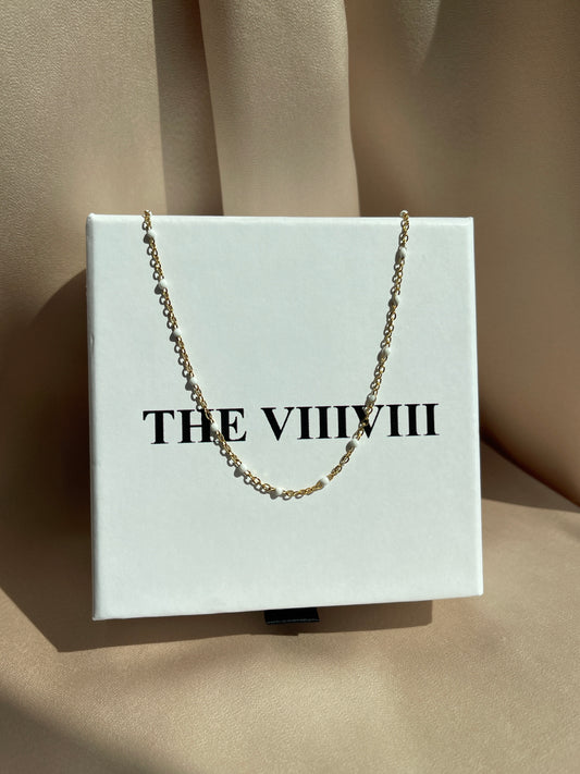 White enamel chain gold 
necklace