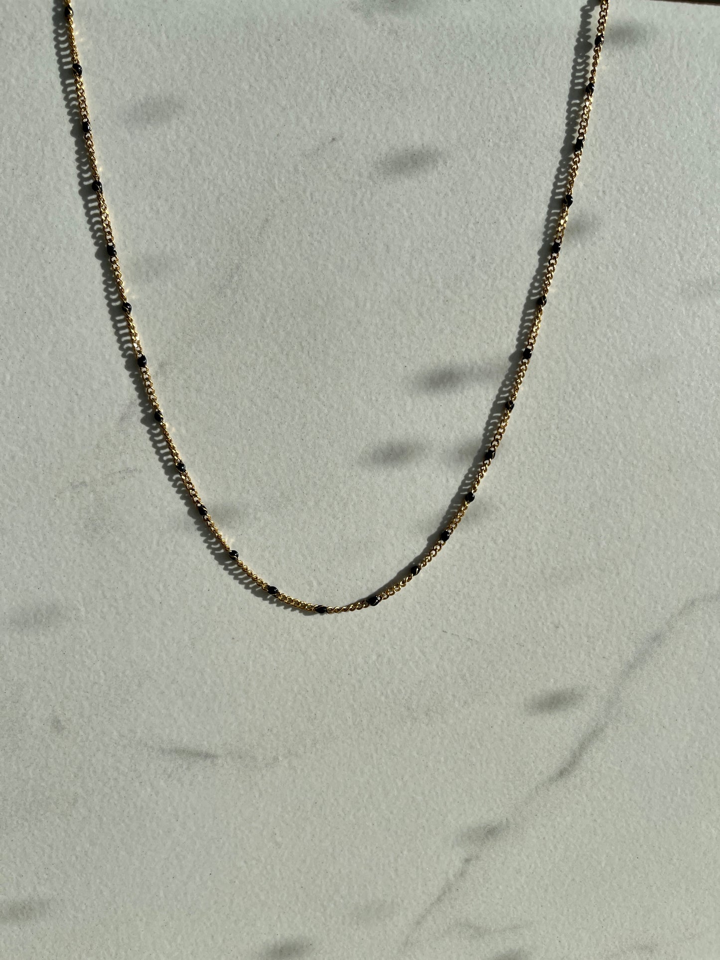 Black enamel chain gold 
necklace