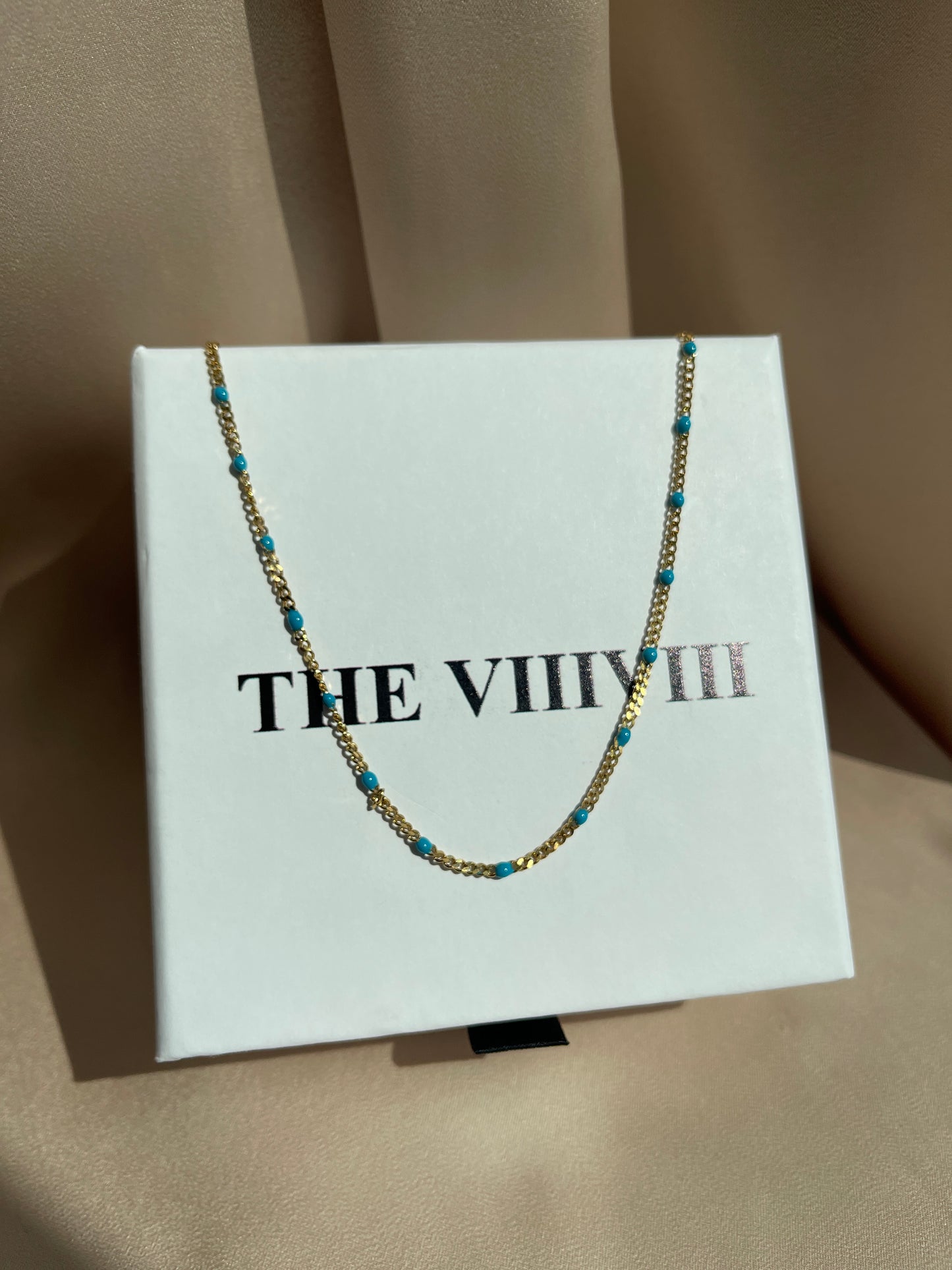 Turquoise enamel chain gold 
necklace